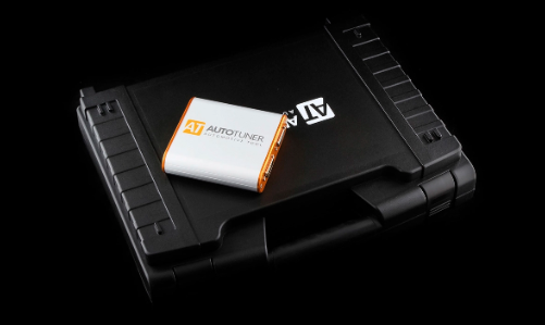 AutoTuner tool resting on an ECU board showing precision connectivity