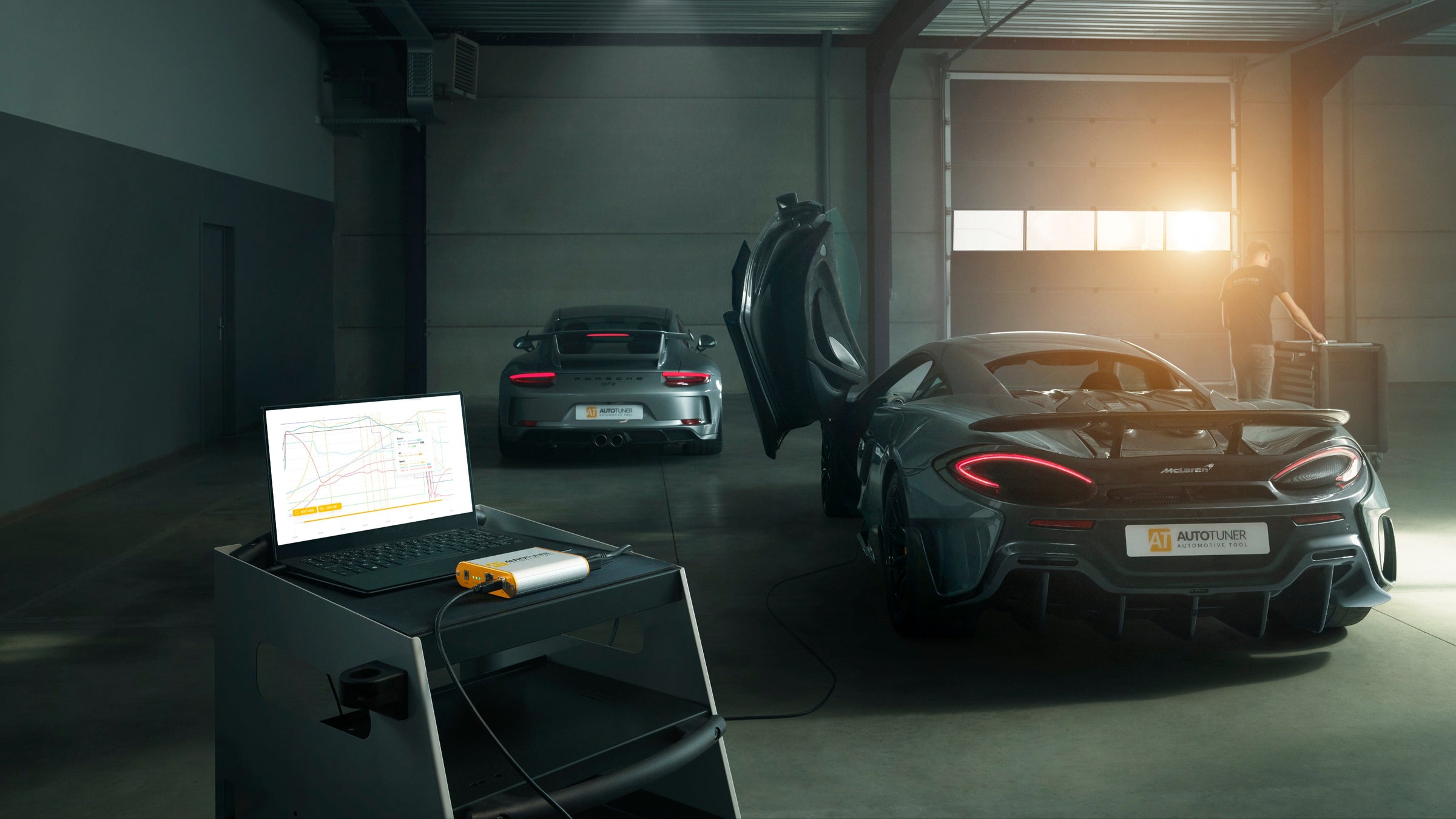 AutoTuner tool connected to McLaren supercar with ZenTune diagnostic setup in a modern garage