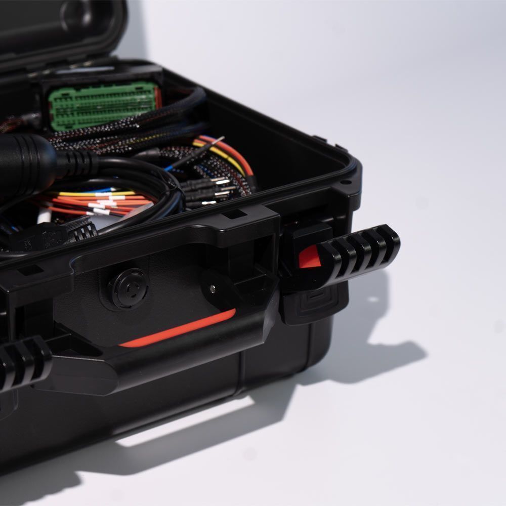 Black electronic case with wires and components on a white background