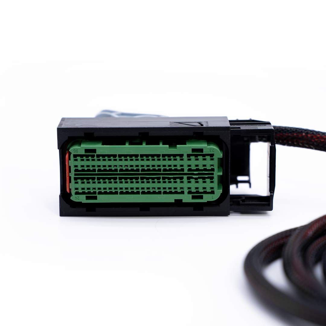 Close-up of a car wiring connector with green connector on a white background