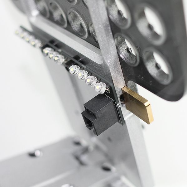 Detailed side view of MAGBench articulated probe arms in locked position